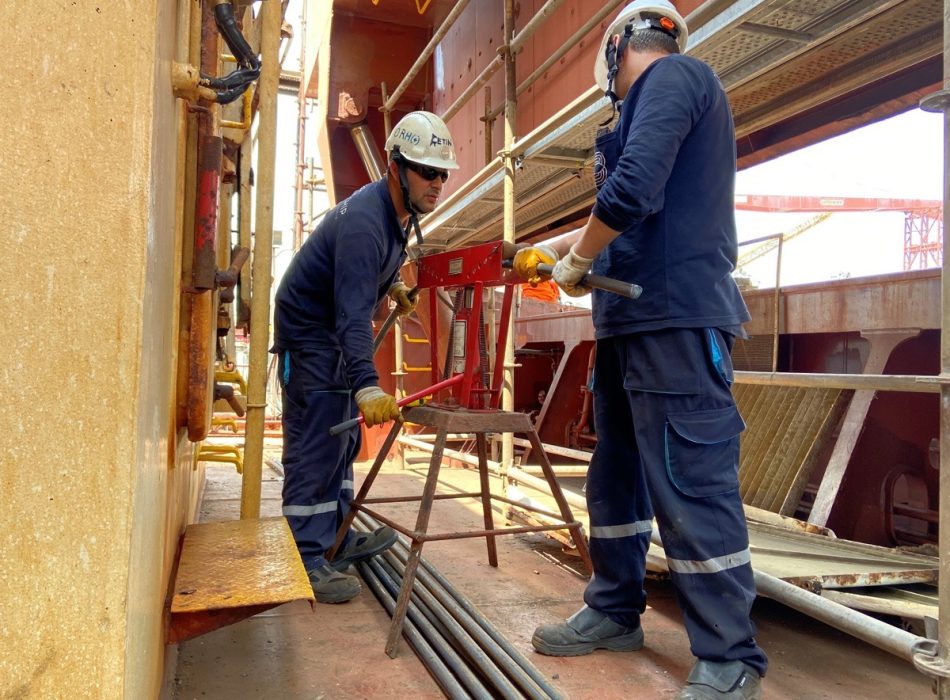 Two Bravo Ship team members collaborate on a project aboard a vessel, showcasing the company's dedication to delivering tailored technical solutions with precision and expertise.