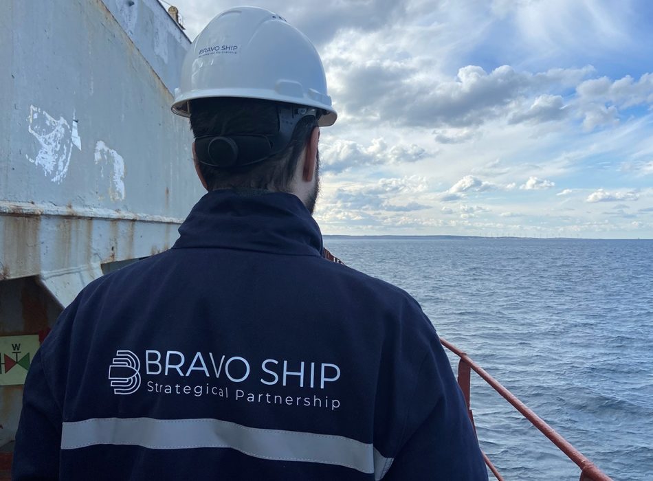 A Bravo Ship team member on the vessel's deck gazes towards the horizon, symbolizing the company's ability to navigate challenges with precision and expertise.