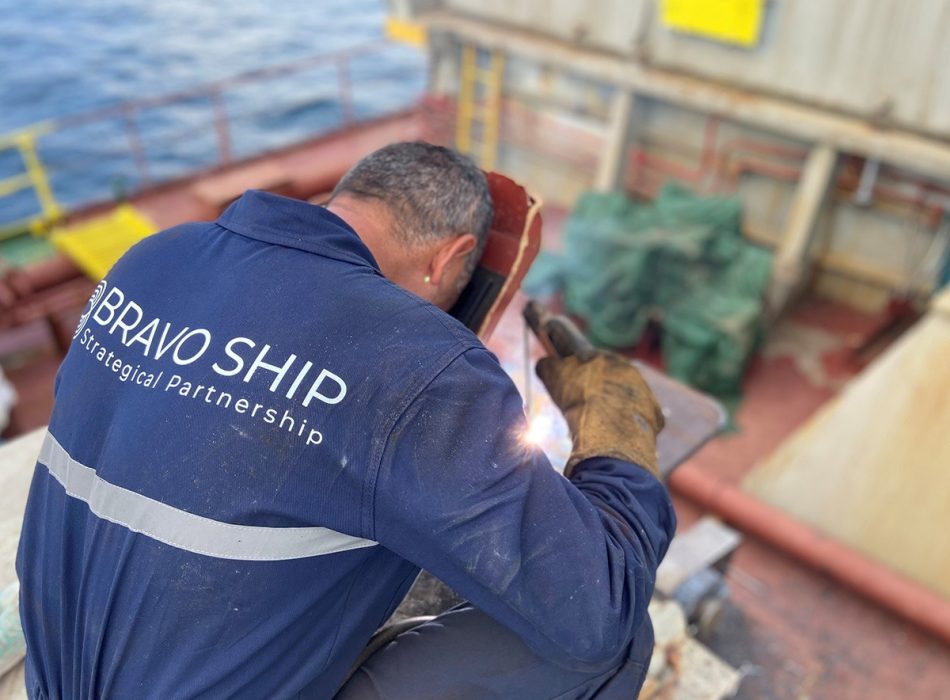 Close-up image of a Bravo Ship technician performing precision welding on a hatch cover repair project.