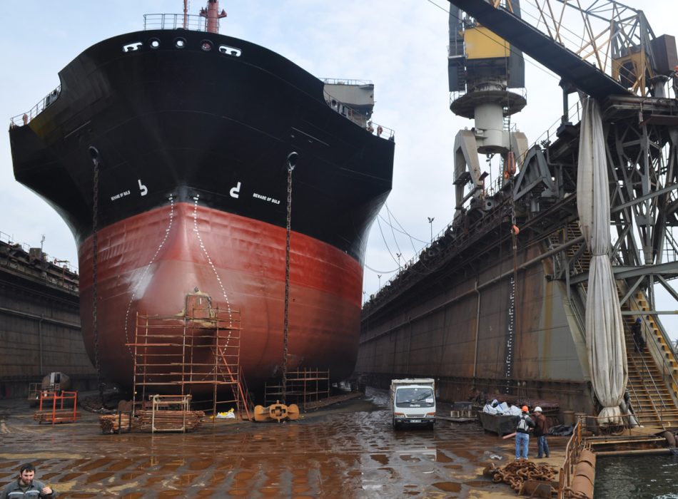 Shipyard operation in Turkey with a large ship in dry dock, overseen by Bravo Ship's expert team.